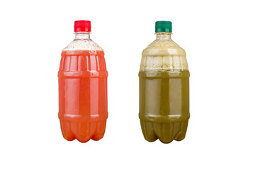 Two plastic bottles with colorful natural juices. Isolated.