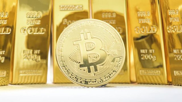 Zoom out slow motion shot of front bit coins in front of many golden bricks or blocks
