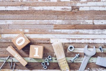 1st May. Happy International Worker's day or Labour Day background concpet.  wooden block calendar 1 May and handy tools on grunge wooden table texture background.