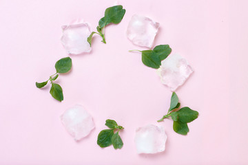 Ice and mint on a pink background close-up, top view