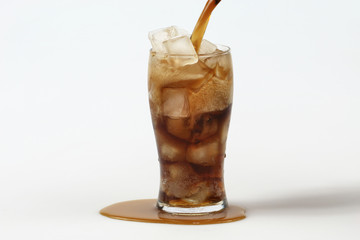 Cola in glass with ice on white background