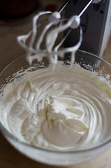 whisking mixer white butter cream to assemble the cake on the occasion