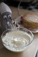 Fototapeta na wymiar whisking mixer white butter cream to assemble the cake on the occasion