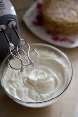 whisking mixer white butter cream to assemble the cake on the occasion
