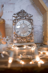 vintage table clock. Vintage interior decor. Gold watches, flashlights, home decoration. Christmas interior. Deer head, candles, porcelain decor.