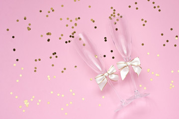 Two glasses of champagne and ribbons on color background. Valentine's Day or Wedding concept