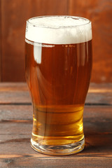 Glass beer on wood background