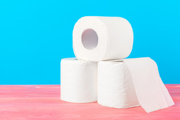 Toilet paper stack on bright blue background