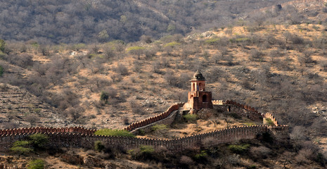 ancient watchtower in the great indian wall overlooking the city of Amer near to the Amber Fort,...