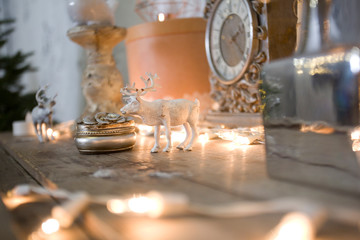 vintage table clock. Vintage interior decor. Gold watches, flashlights, home decoration. Christmas interior. Deer head, candles, porcelain decor.