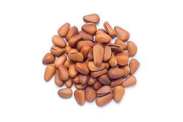 Pile of pine nuts isolated on white background. Top view.