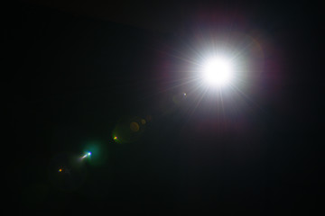 Flash of a distant abstract star. Abstract sun flare. The lens flare is subject to digital...