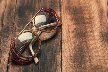 old glasses on wooden surface