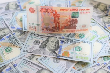 Fototapeta na wymiar Russian Roubles and U.S. Dollars Closeup Concept. American Dollars Cash Money. One Hundred Dollar Banknotes