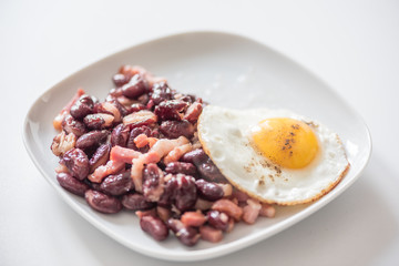 English tastefull breakfast with fried bacon, beans and eggs