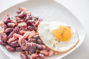 English tastefull breakfast with fried bacon, beans and eggs