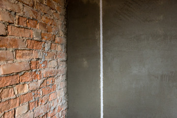 Plaster on beacons on a brick wall.