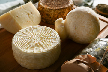 Fototapeta na wymiar Assortment of tasty cheese on wooden board