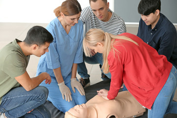 People learning to perform CPR at first aid training course