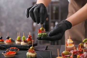 Chef preparing tasty canapes for serving