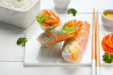 Tasty spring rolls on white table