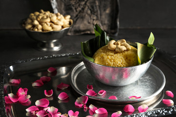 Bowl with traditional Indian food pongal on table