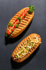 Tasty hot dogs on dark background