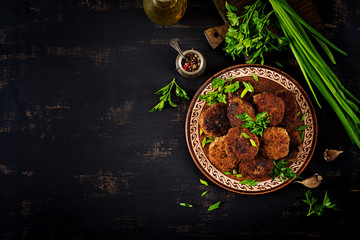 Juicy delicious meat cutlets on a dark table. Russian cuisine. Top view