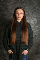 Fototapeta premium Portrait of stylish woman on grunge background