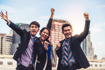 Happy businessmen and businesswoman celebrate success in project task achievement. Concept of...