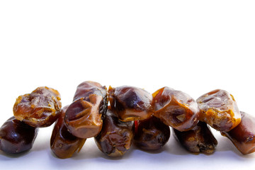 Sweet dry dates laid out in two rows, isolated on a white background. copy paste