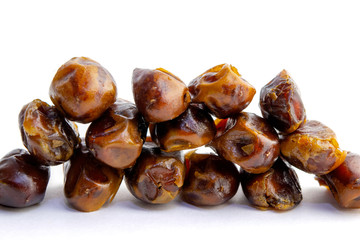 Three rows of sweet dry dates isolated on white background.