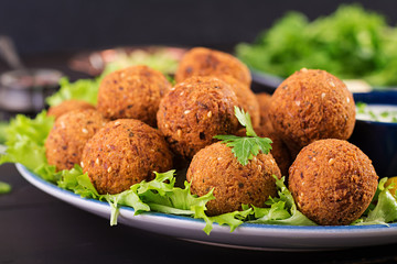 Falafel, hummus and pita. Middle eastern or arabic dishes on a dark background. Halal food.