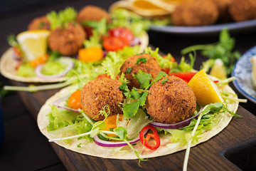 Tortilla wrap with falafel and fresh salad. Vegan tacos. Vegetarian healthy food.