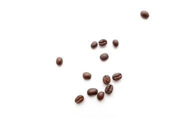 Roasted coffee beans isolated on white background. Close-up.