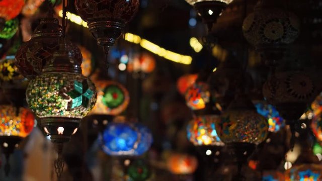 Camera moving throught traditional turkish lamps at night time