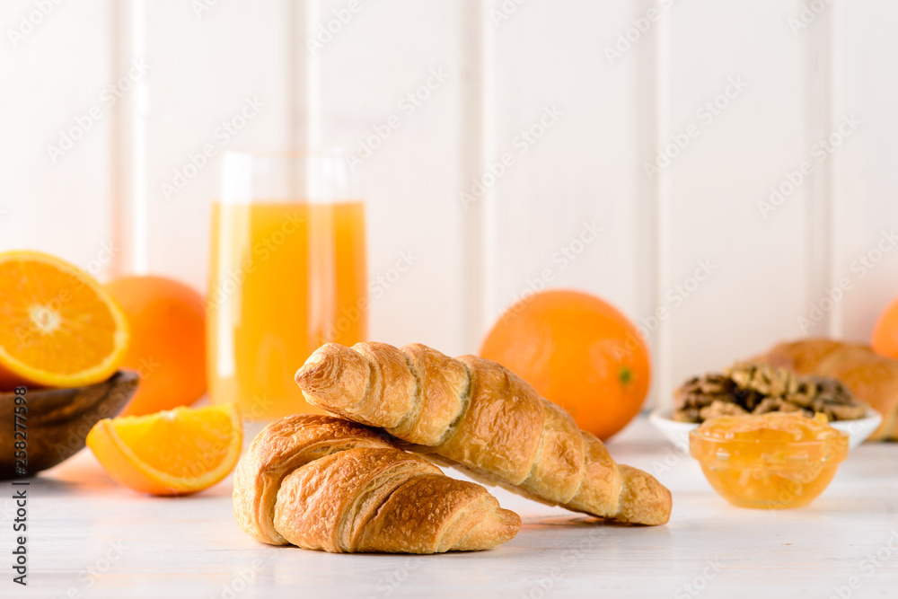 Wall mural fresh croissant for breakfast with orange juice, breakfast concept