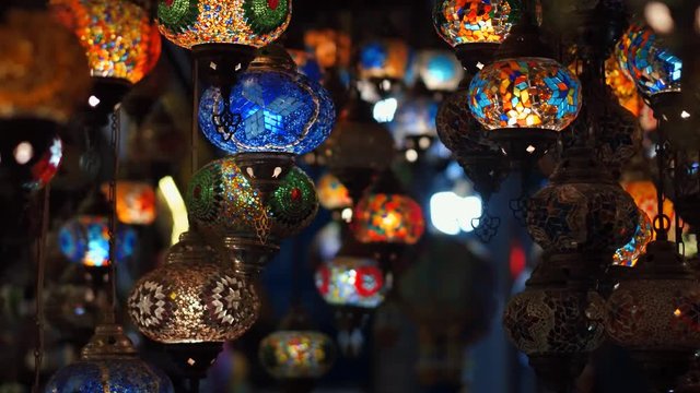 Camera moving around blue traditional turkish lamps at night time