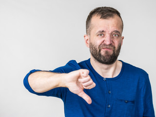 Adult man showing thumbs down gesture