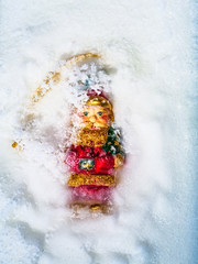 Santa Claus toy frozen in the ice