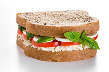 Sandwich with mozzarella cheese and tomatos  on white background.