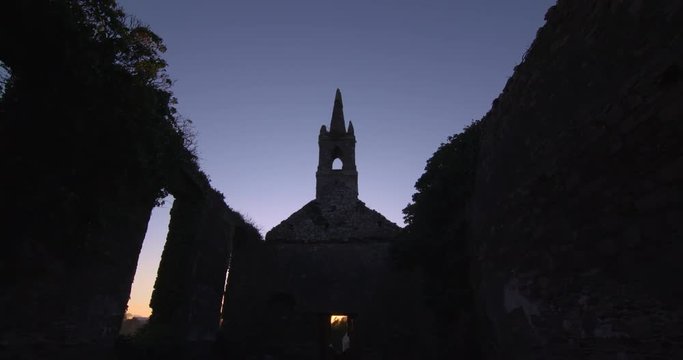 POV Church building steeple windows Ireland ruins summer sunset silhouette