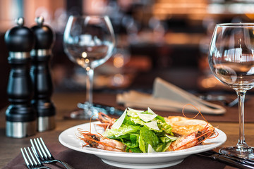 Shrimps with parmesan in a plate on the table