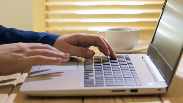 Laptop keyboard. Close up shot of man scrolling a Website Using Laptop Track Pad