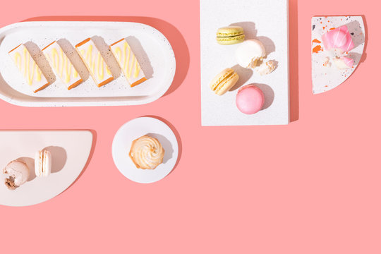 Assorted Colorful Dessert Cakes on Bright Background, Minimal and Isolated with Copy Space