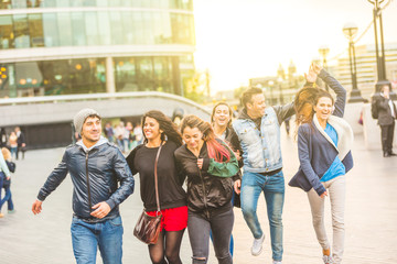 Multiracial group friends having fun in the city at sunset