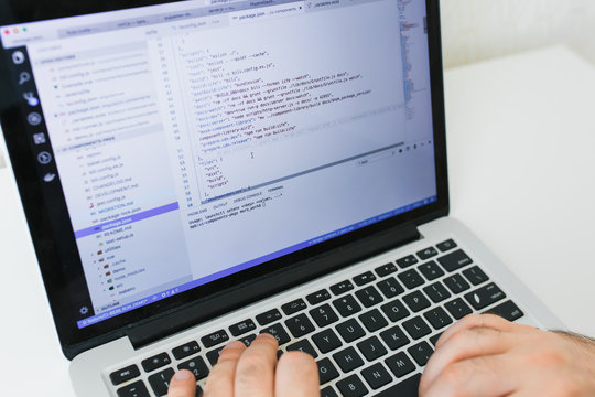 Closeup coding on screen, man hands coding html and programming on screen laptop, development web, developer