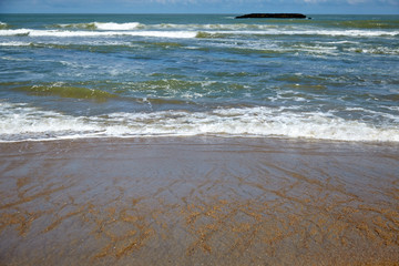 Sea water, waves and wet sand on beach