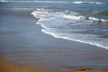 Sea water, waves and wet sand on beach