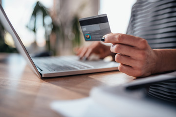 Woman shopping online and using credit card